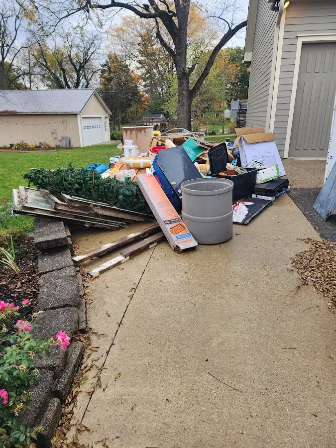 Dumpster being loaded with debris for 3 Yard Dumpster Rental in Richland